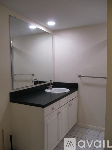 A bathroom with a sink and mirror.