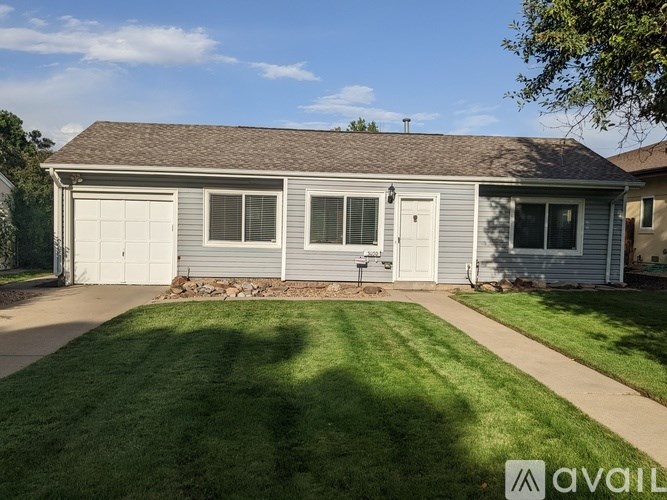 A house with a garage and a lawn in front.