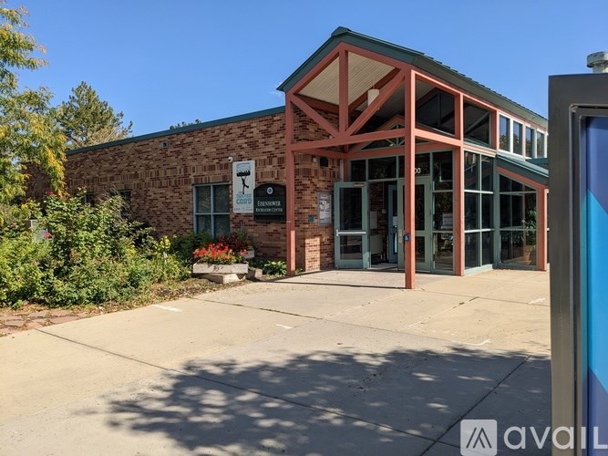 A building with a sign that says "AVAIL" in front of it.