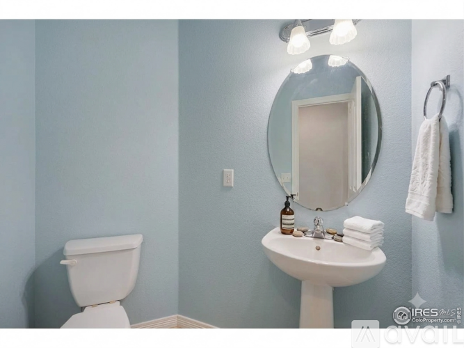 A bathroom with a sink, toilet, and shower curtain.