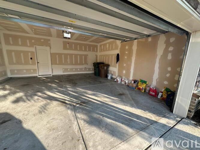 A black and yellow step ladder is leaning against a wall in a room under construction.