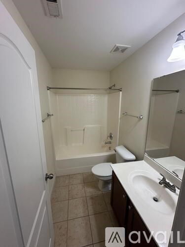 A bathroom with a toilet, sink, and bathtub.