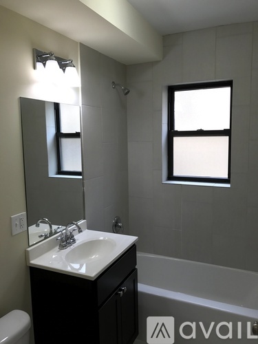 A bathroom with a sink, mirror, and toilet.
