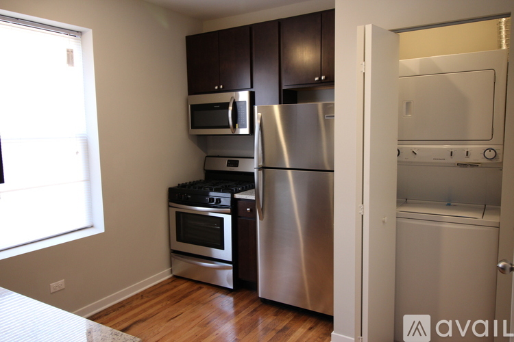 A kitchen with stainless steel appliances and wooden cabinets.