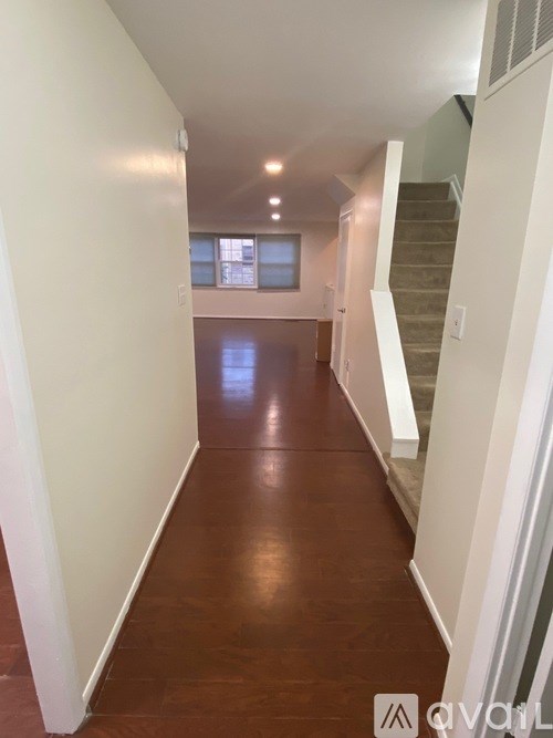 A long hallway with a staircase on the right side.