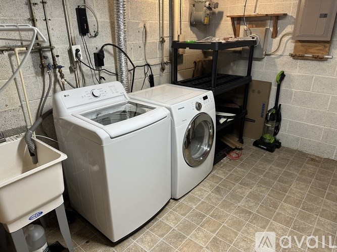 A white washing machine and dryer in a laundry room.