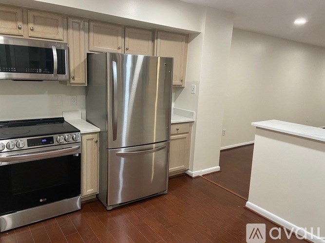 A kitchen with a stainless steel refrigerator, oven, and microwave.
