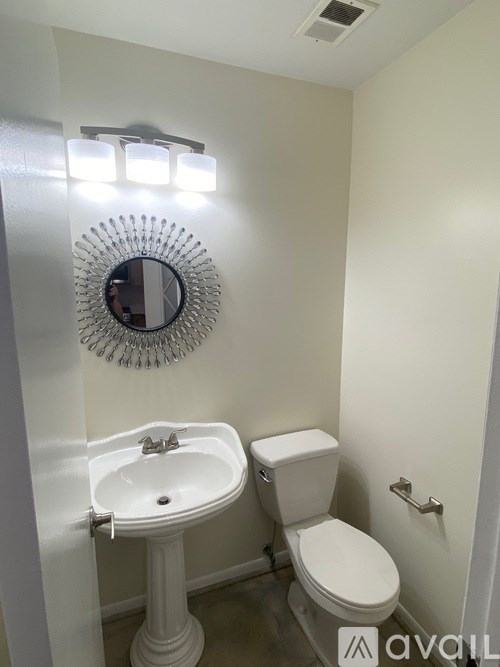 A white sink and toilet in a small bathroom.