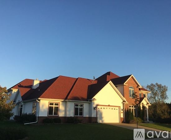 A house with a red roof and a sign that says "available" in front of it.