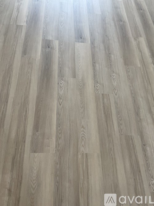 A wooden floor with a logo that reads "avail".