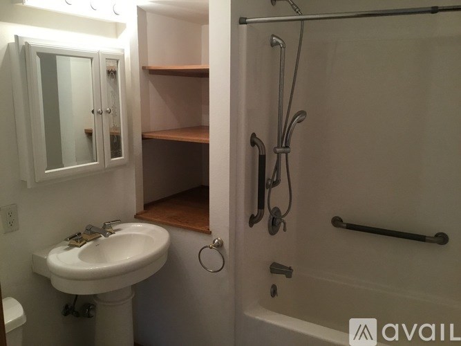 A bathroom with a sink, toilet, and shower.