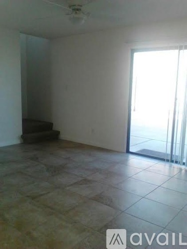 A room with tiled flooring and a ceiling fan.