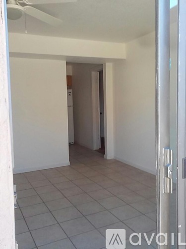 A room with a tiled floor and a ceiling fan.