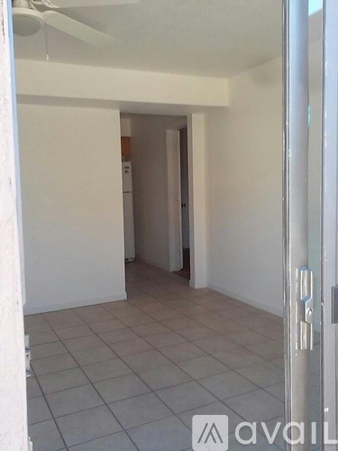 A room with a tiled floor and a ceiling fan.