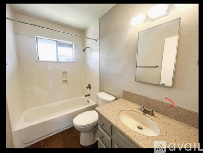 A bathroom with a toilet, sink, and bathtub.