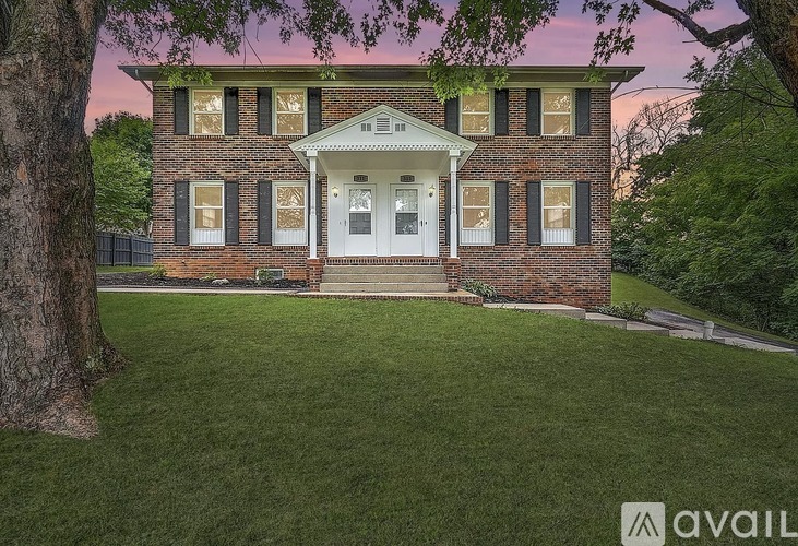 A brick house with a white door and windows.