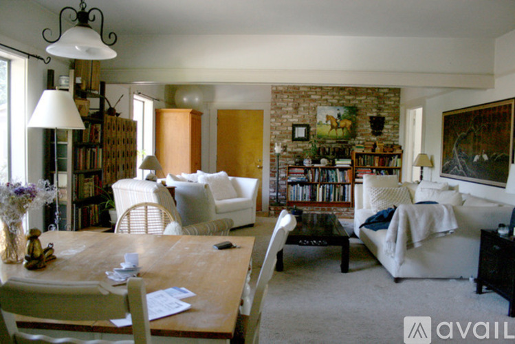 A living room with a brick wall and a white couch.