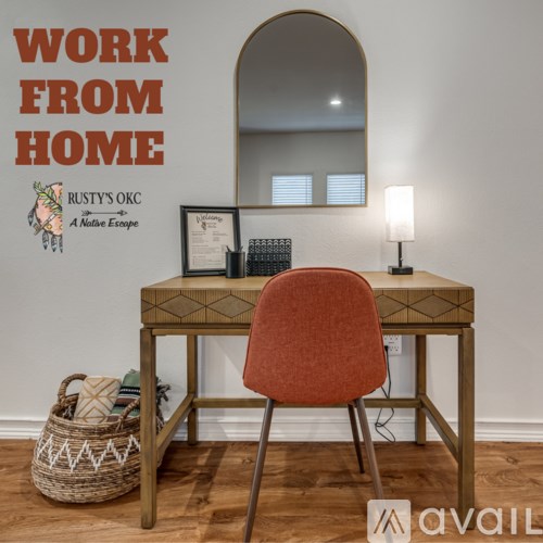 A desk with a chair and a mirror in front of a wall with the text "WORK FROM HOME" on it.