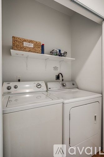 A small laundry room with a washer and dryer.