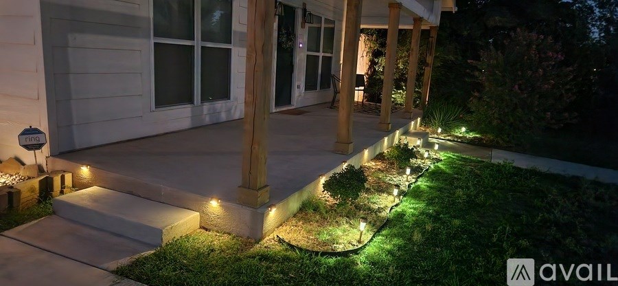 A house with a porch and lights on the steps.