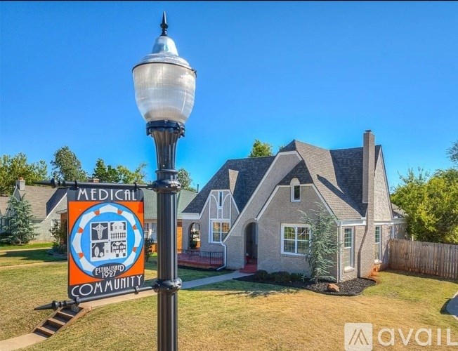A house with a sign that says "Medical Community" in front of it.
