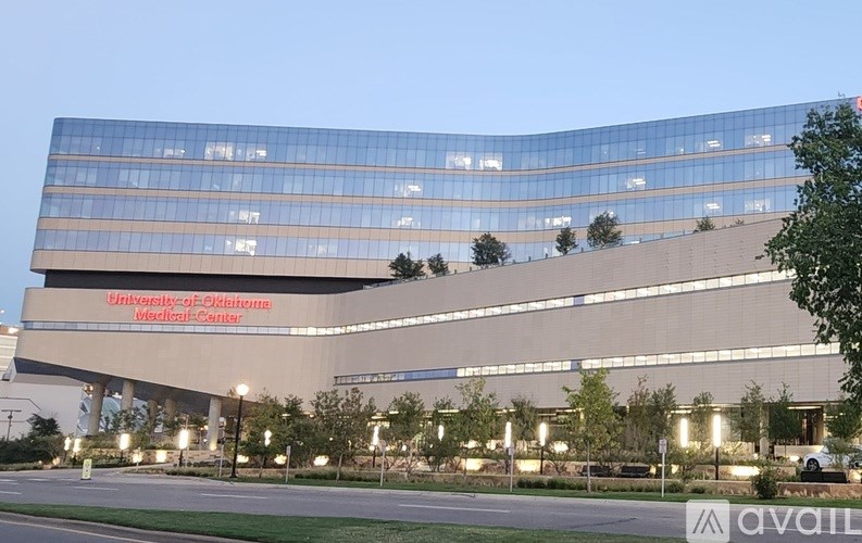 The exterior of the University of Pittsburgh Medical Center building is shown at dusk.