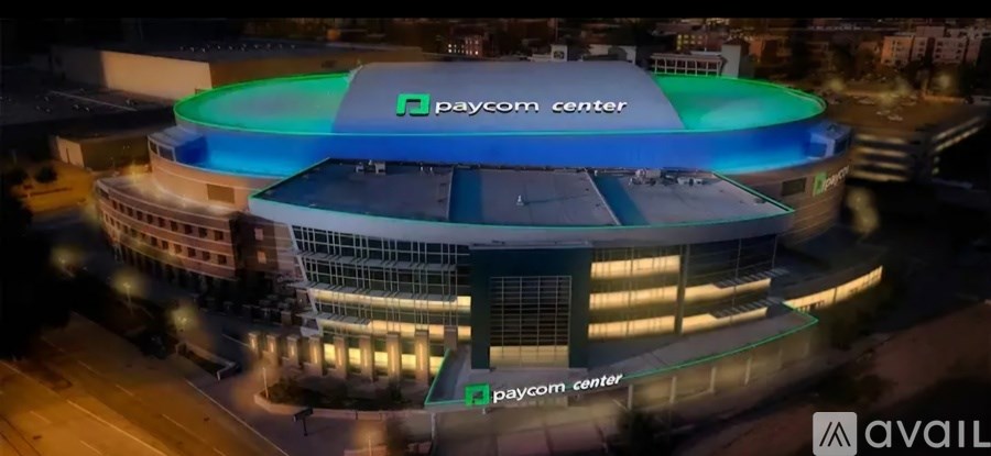 A Paycom Center is shown at night with its exterior illuminated.
