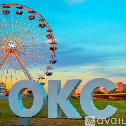 A large ferris wheel with the letters OKC in the foreground.
