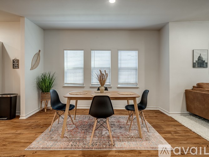 A dining room with a table set for four.