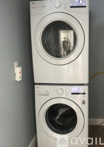 A white washing machine with a digital display on the front.