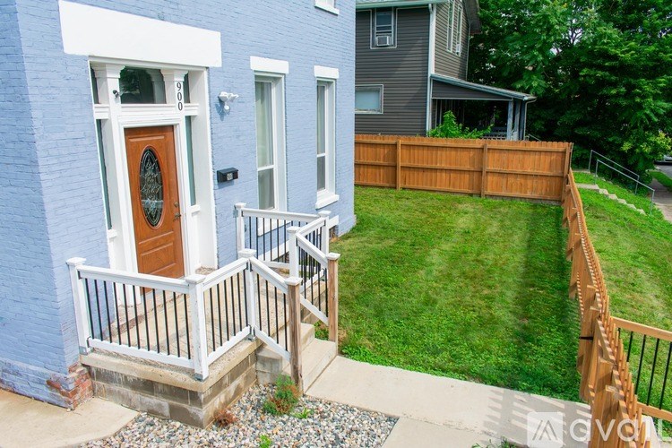 A dining room with a table set for four and a couch.