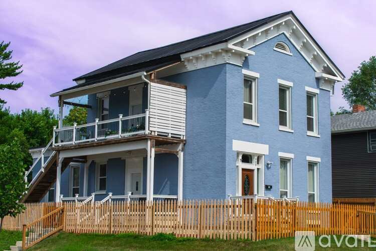 A dining room with a wooden table and chairs.