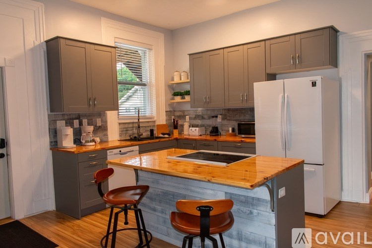 A bedroom with a bed, desk, and chair.