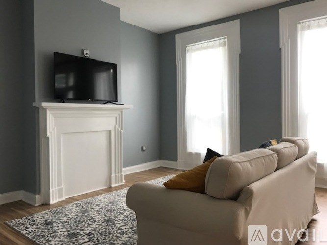 A living room with a fireplace and a couch.