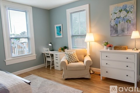 A bedroom with a large bed and a nightstand.