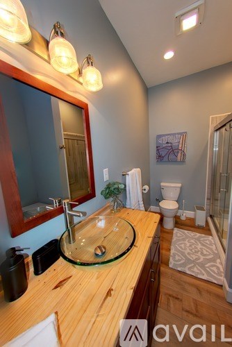 A dining room with a table and chairs.