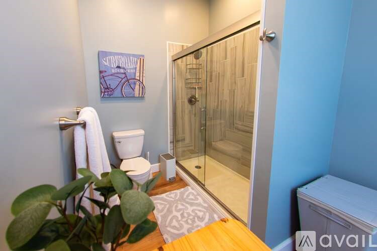 A blue house with a wooden fence in front.