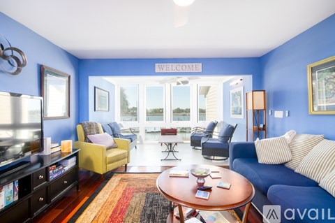 A living room with a blue wall and a sign that says "Welcome".