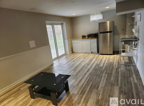 A kitchen with a wooden floor and a black coffee table.
