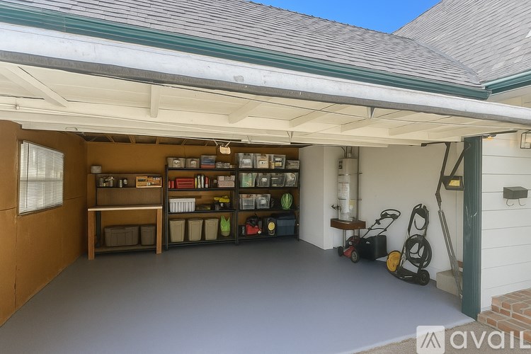 A garage with a white ceiling and a green door.