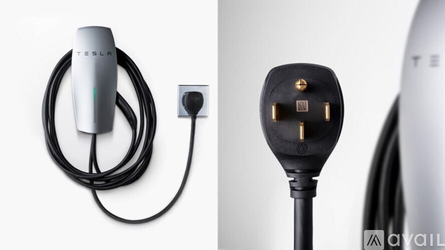 A Tesla charging cable plugged into a wall socket.