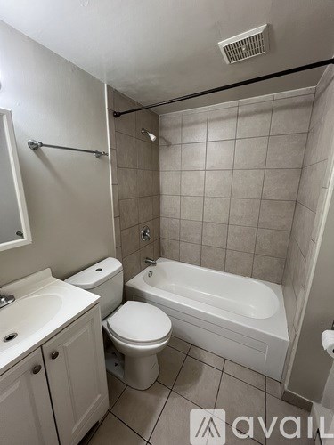 A bathroom with a toilet, sink, and bathtub.