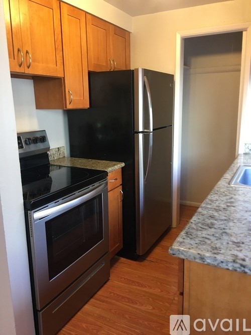 A kitchen with a black fridge and stove.
