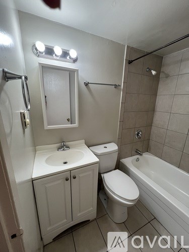 A small bathroom with a toilet, sink, and bathtub.