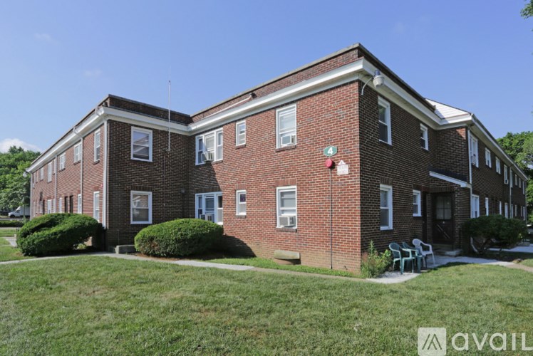 A red brick building with a green lawn in front.