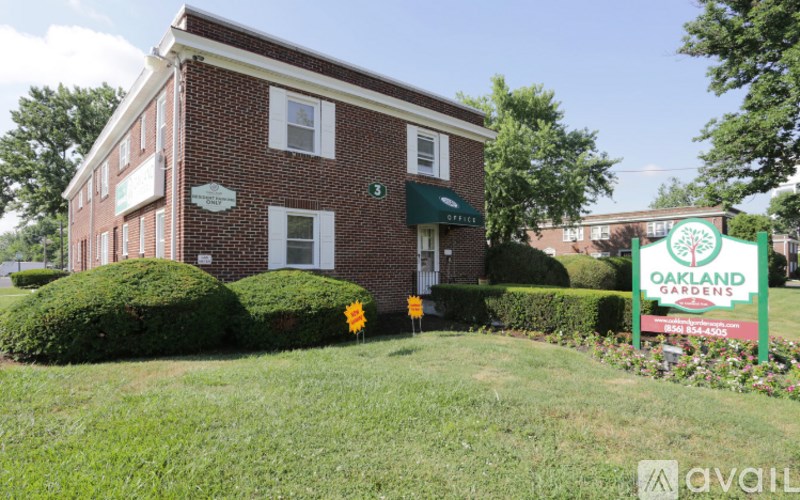 A brick building with a green lawn in front.