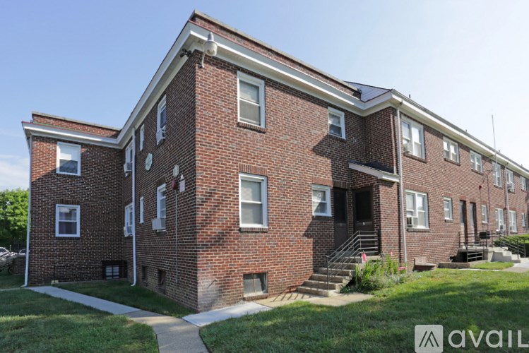 A red brick building with a white trim and a small porch.