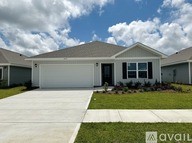 A house with a garage and a driveway in front.
