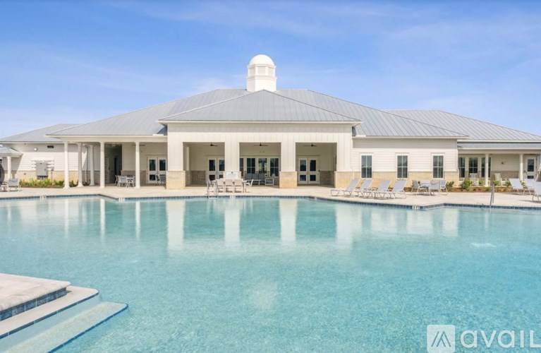 A large house with a pool in front.