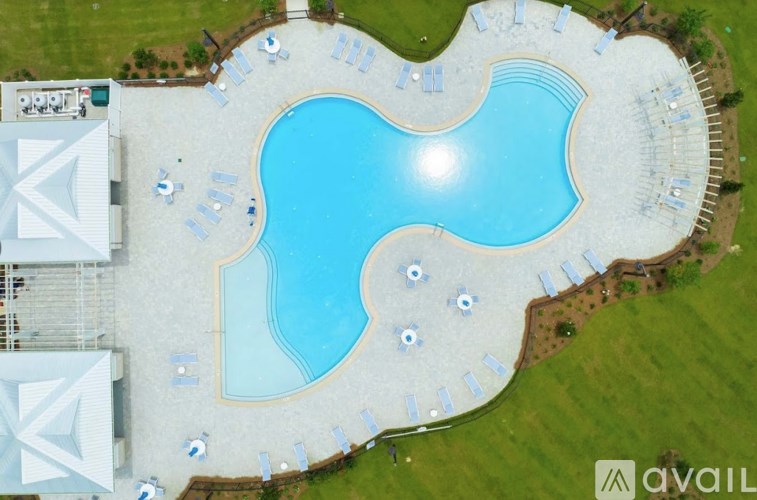 A large outdoor swimming pool surrounded by lounge chairs.